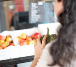 A person holding fresh produce at the market.