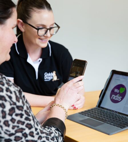 Guide Dogs Client learning to use assistive features on a smart phone and laptop.