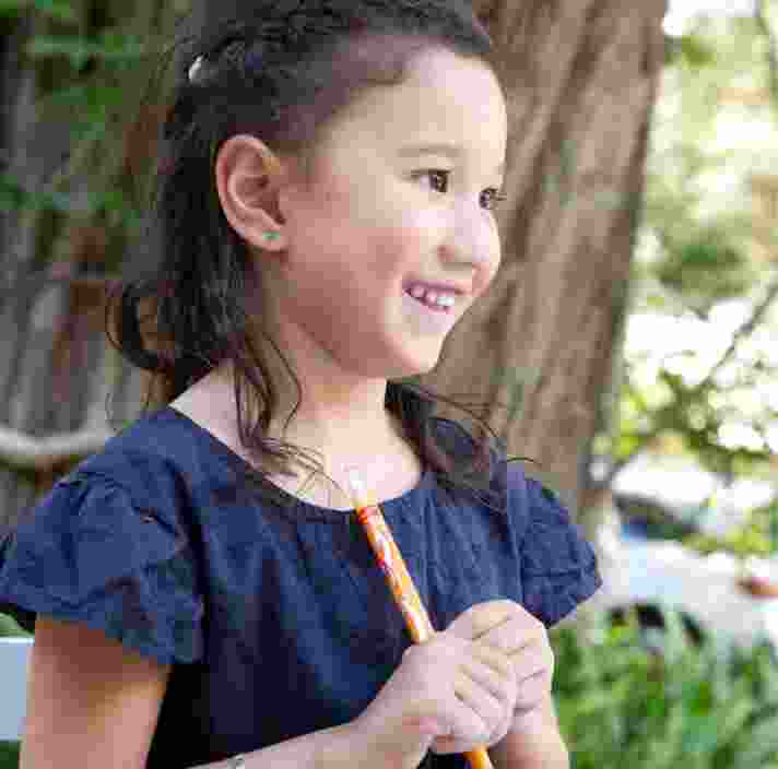 A young child smiling.