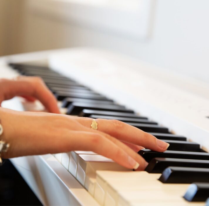 A person's hands playing the piano.